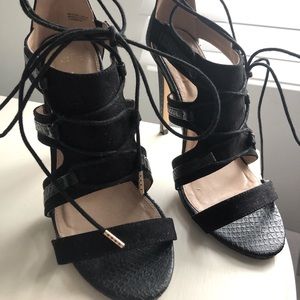 Black lace-up faux leather 4in/100mm heels.